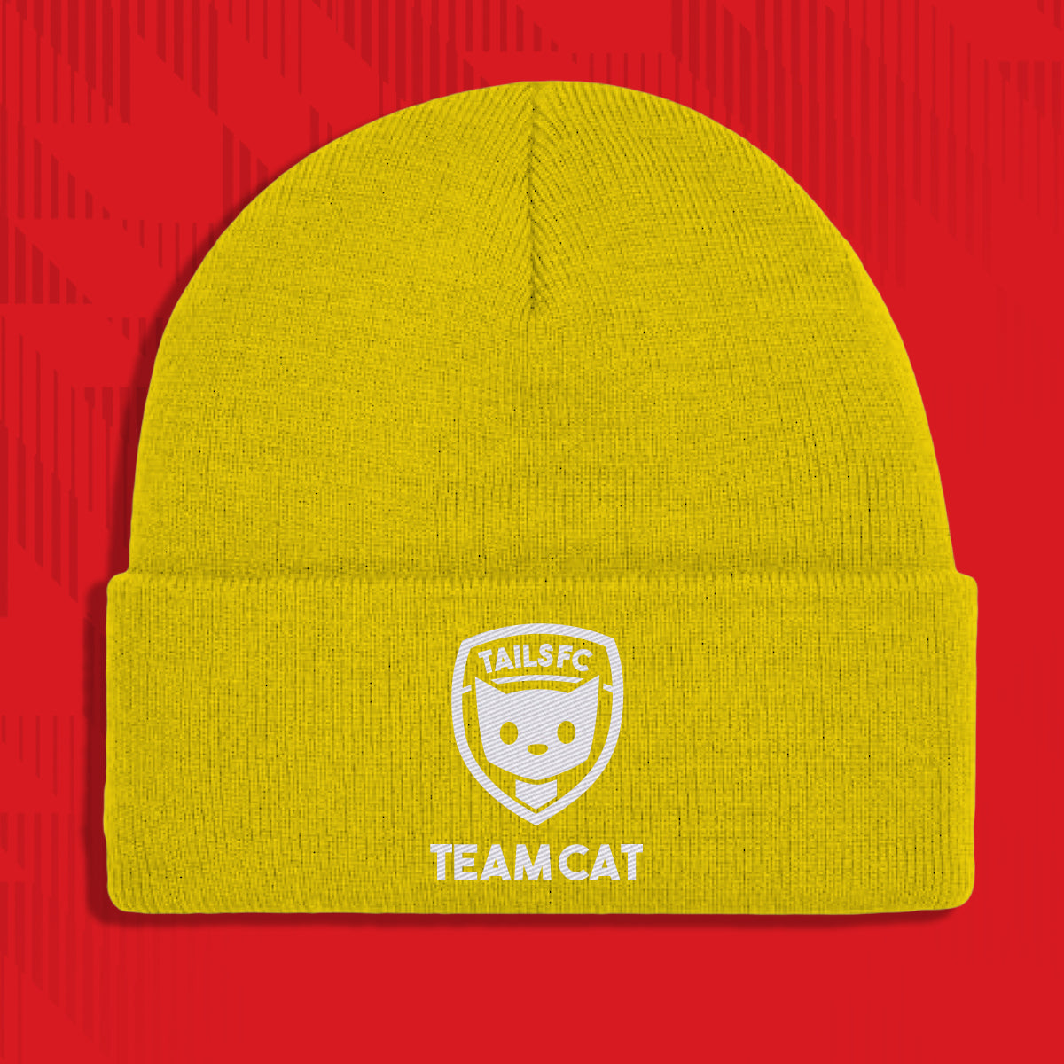 Yellow beanie with 'TAILS FC TEAM CAT' logo on a red background
