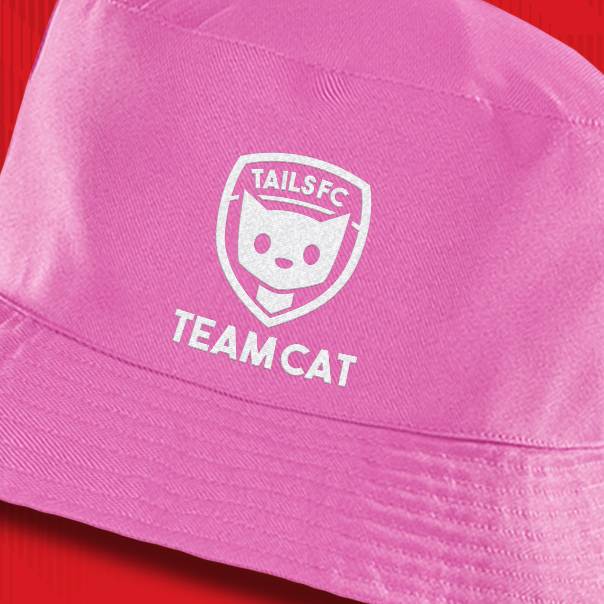 Pink cap with 'TAILS FC TEAM CAT' logo on a red background