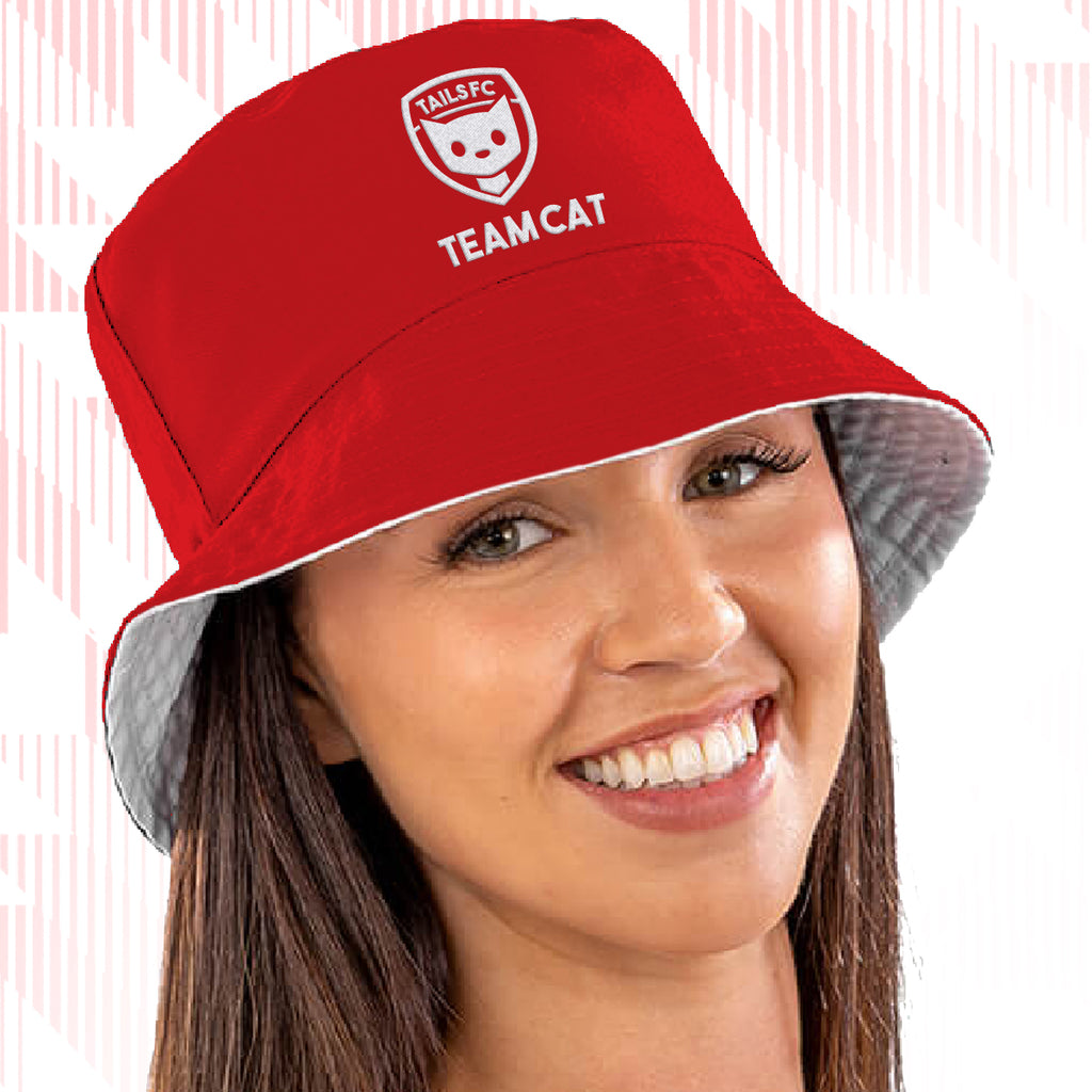 Tails FC Red bucket hat with 'Team Cat' logo worn by a person on a white background
