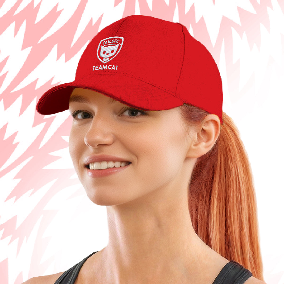 Woman wearing Tails FC  red cap with Team Cat logo and text on a pink background