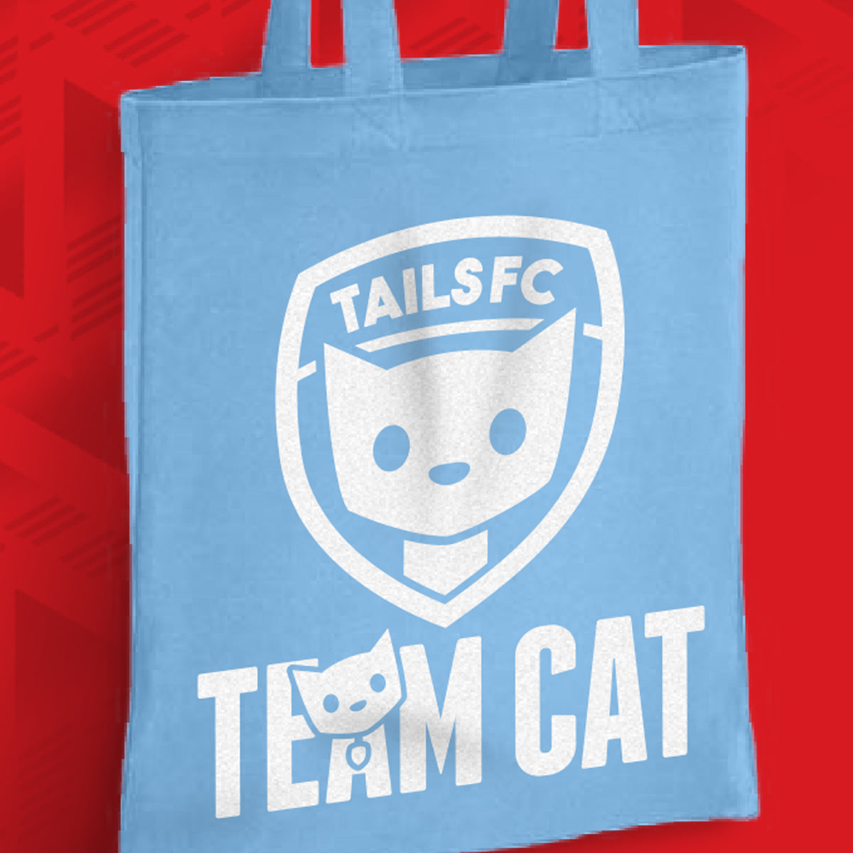 Light blue tote bag with 'TAILSFC Team Cat' design on a red background