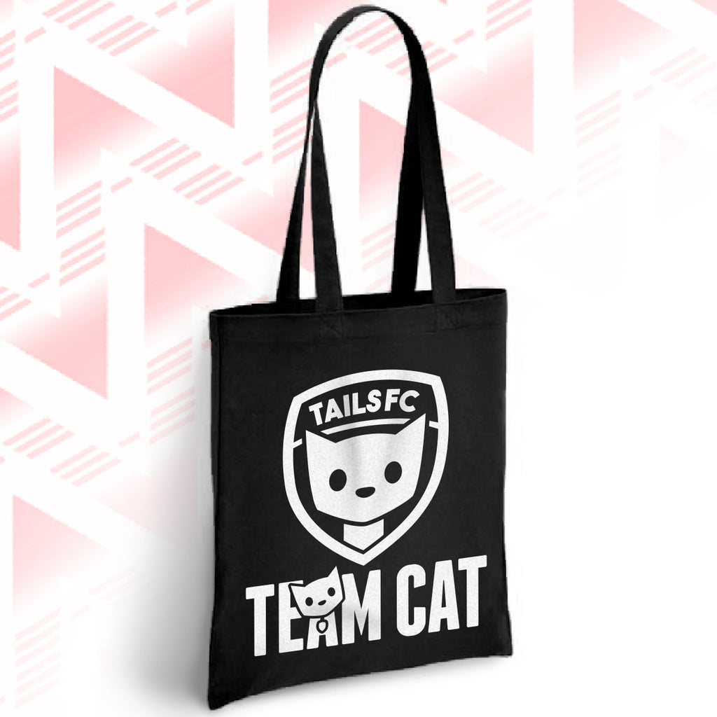 Black tote bag with 'TAILSFC Team Cat' design on a pink geometric patterned background
