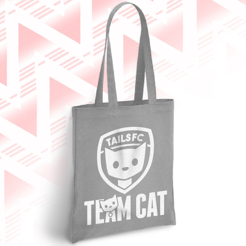 Gray tote bag with 'TAILSFC Team Cat' design on a pink and white geometric patterned background