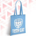Blue tote bag with 'TAILSFC Team Cat' design on a pink and white geometric patterned background