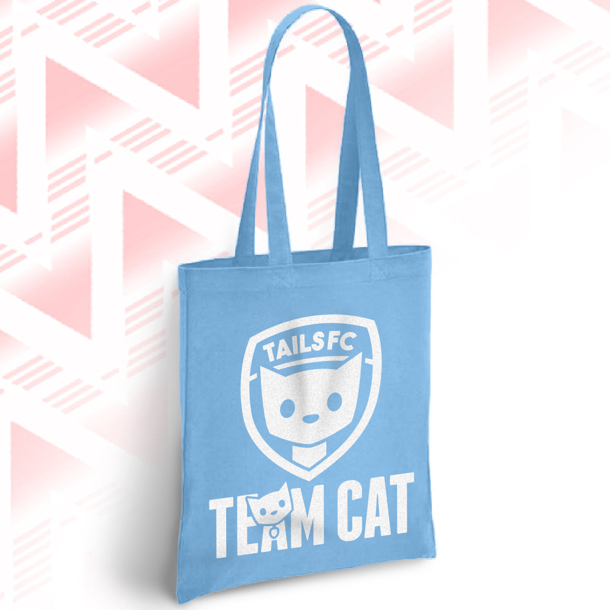 Blue tote bag with 'TAILSFC Team Cat' design on a pink and white geometric patterned background