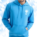 Man wearing a blue Tails FC hoodie with Team Dog logo on a light blue background