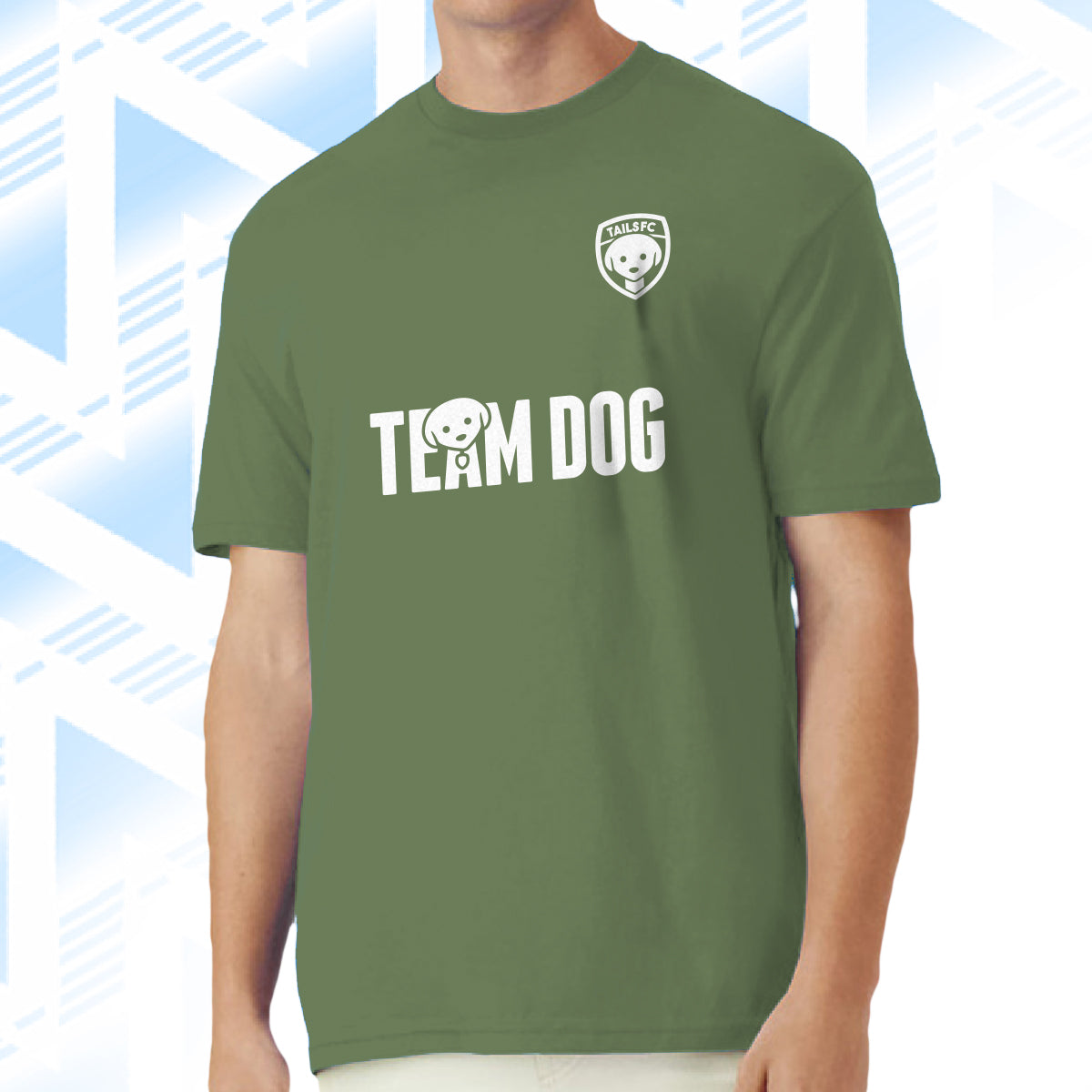 Tails FC Green t-shirt with 'Team Dog' text and logo on a man against a blue geometric patterned background