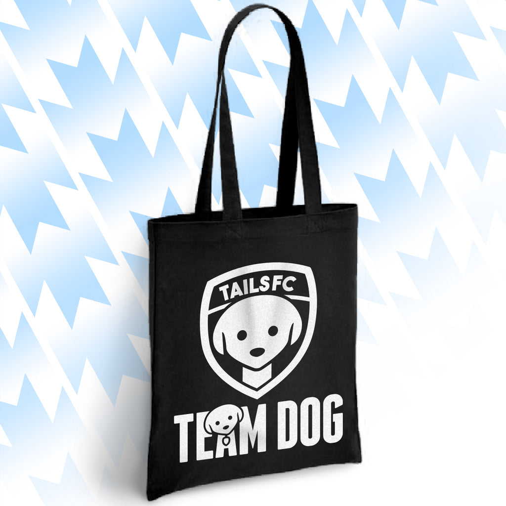 Black tote bag with 'TAILSFC Team Dog' logo on a light blue background
