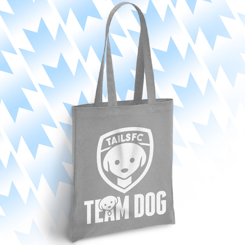 Gray tote bag with 'TAILSFC Team Dog' logo on a light blue background