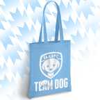 Light blue tote bag with 'TAILSFC Team Dog' design on a light blue abstract background
