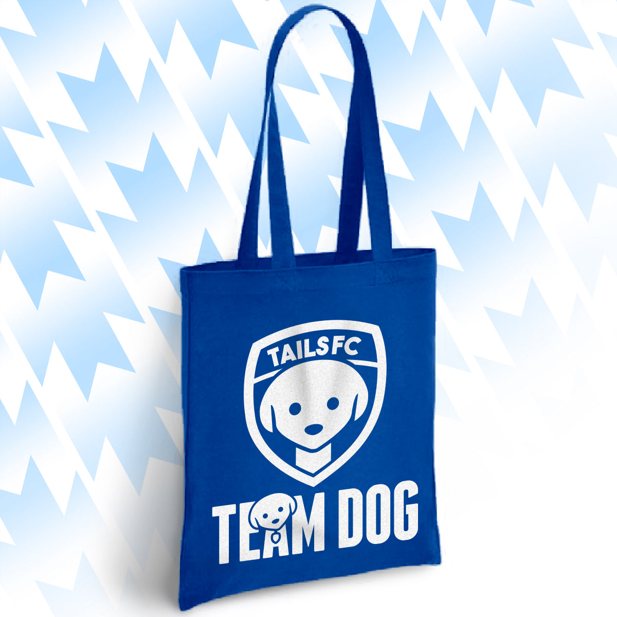 Blue tote bag with 'TAILSFC Team Dog' logo on a light blue background
