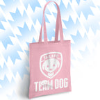 Pink tote bag with 'TAILSFC Team Dog' design on a light blue background