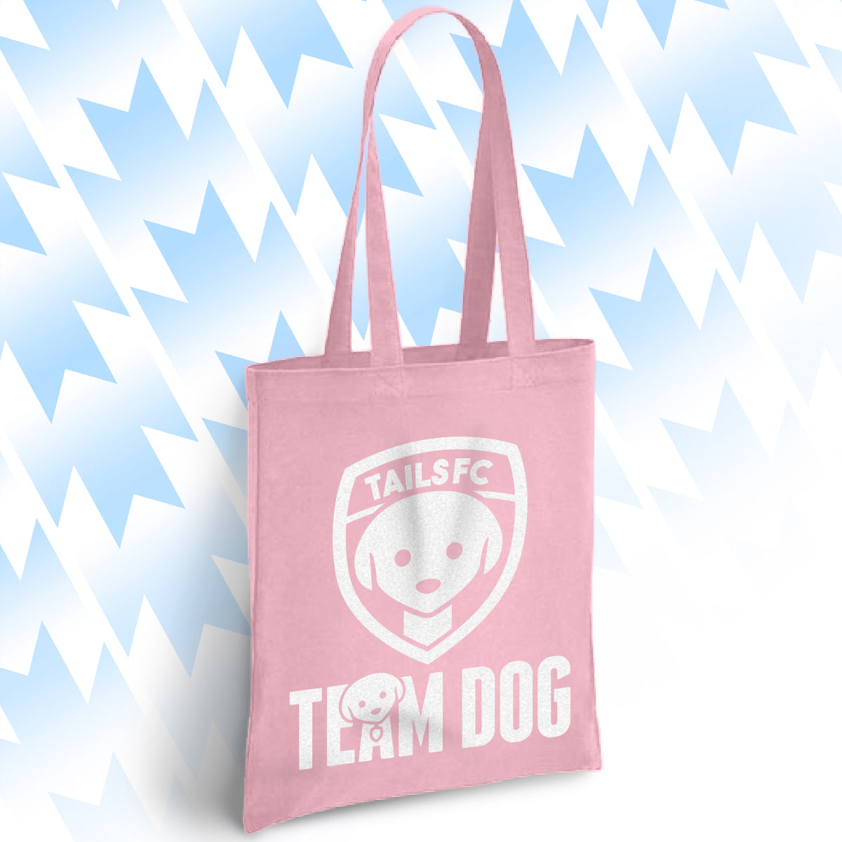 Pink tote bag with 'TAILSFC Team Dog' design on a light blue background