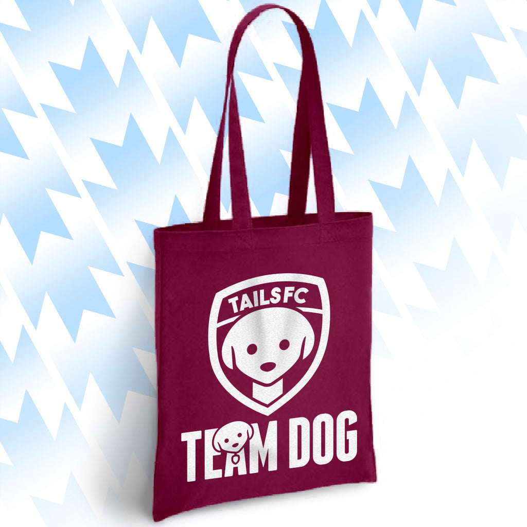 Maroon tote bag with 'TAILSFC Team Dog' logo on a light blue background