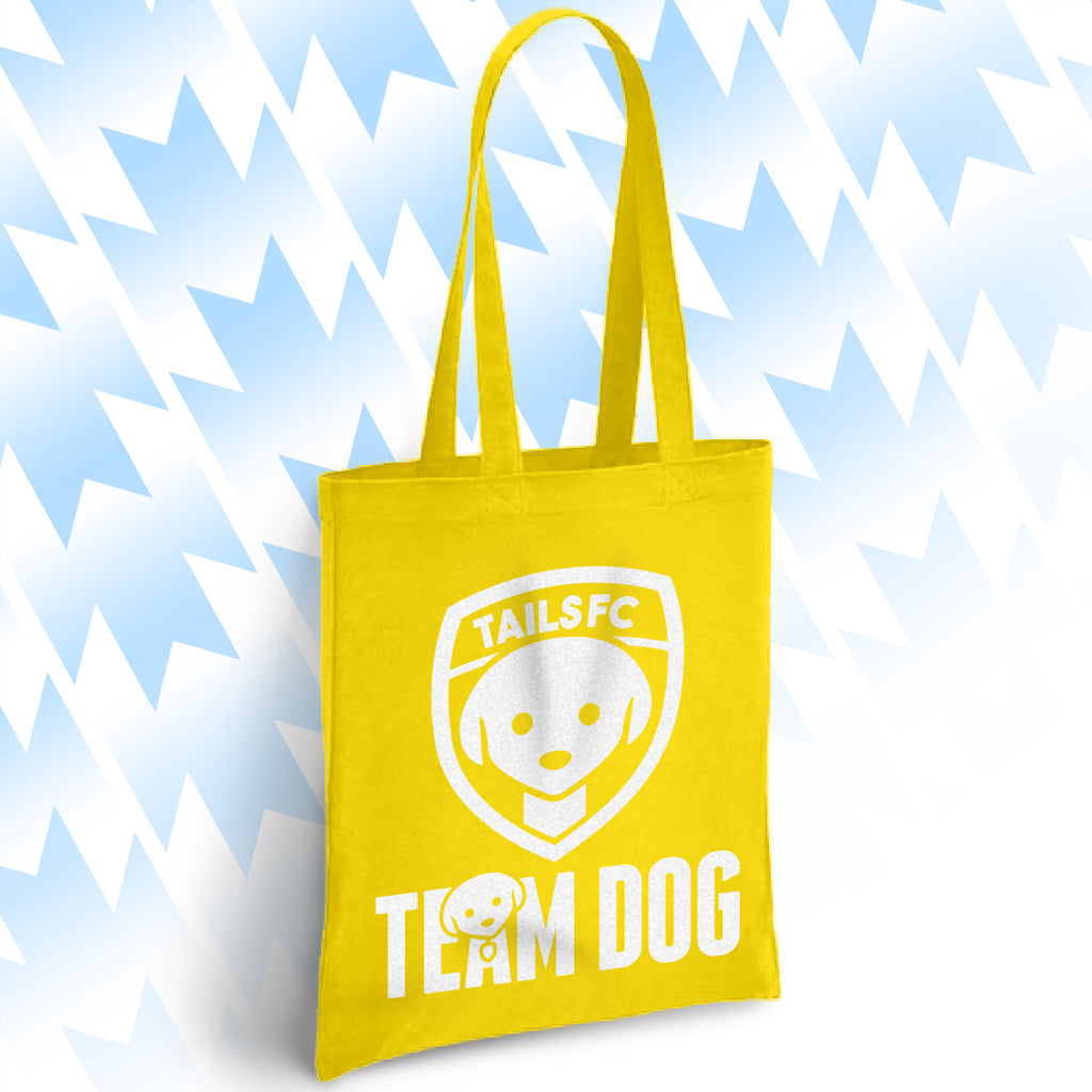 Yellow tote bag with 'TAILSFC Team Dog' logo on a light blue background