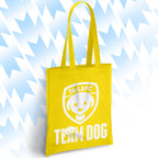 Yellow tote bag with 'TAILSFC Team Dog' logo on a light blue background