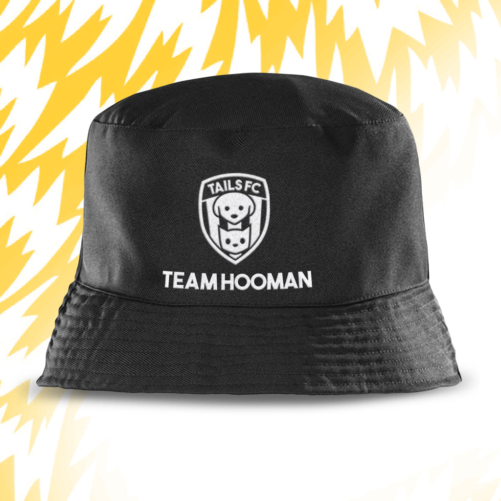 Black bucket hat with 'Tails FC' logo and 'Team Hooman' text on a yellow and white background