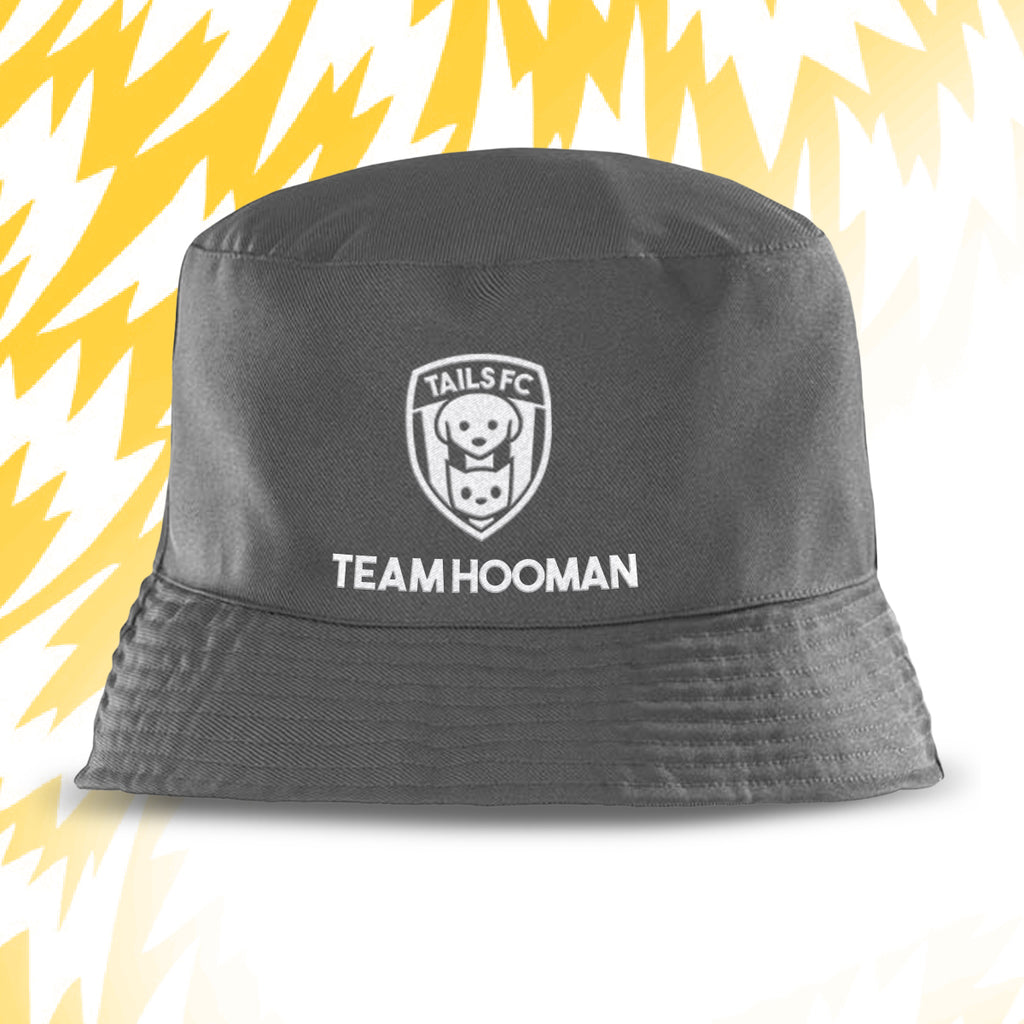 Gray bucket hat with 'Tails FC' and 'Team Hooman' text on a yellow and white background