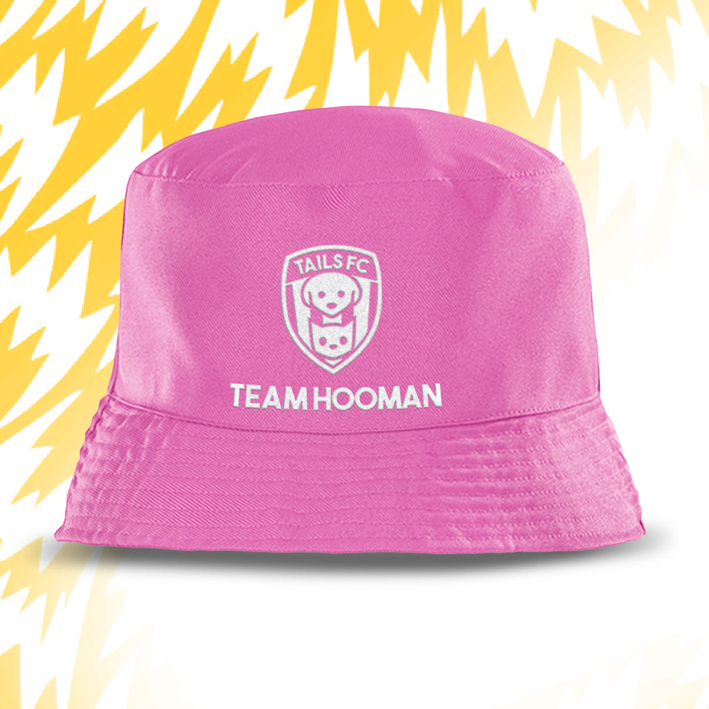 Pink bucket hat with 'Tails FC' and 'Team Hooman' text on a yellow and white background