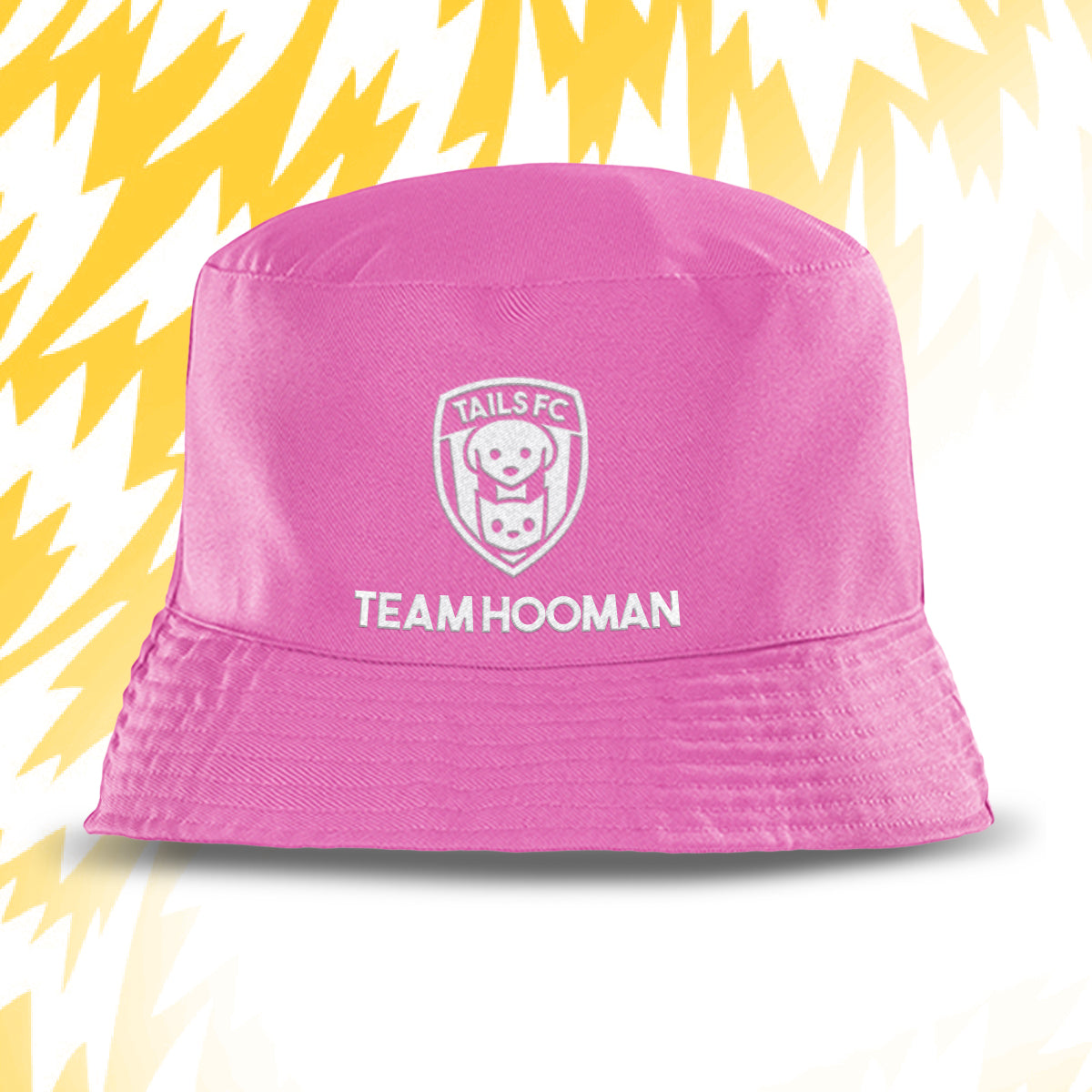 Pink bucket hat with 'Tails FC' and 'Team Hooman' text on a yellow and white background