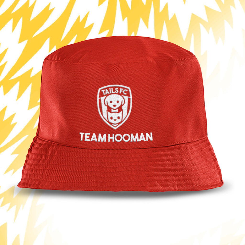 Red bucket hat with 'Team Hooman' and 'Tails FC' logo on a yellow and white abstract background