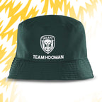 Green bucket hat with 'Tails FC' and 'Team Hooman' text on a yellow and white abstract background