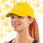 Woman wearing a yellow Tails FC cap with Team Hooman logo on a yellow background
