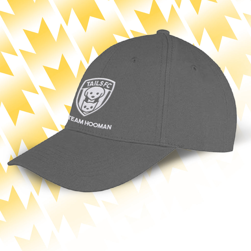 Tails FC Gray cap with logo and text on a yellow and white abstract background