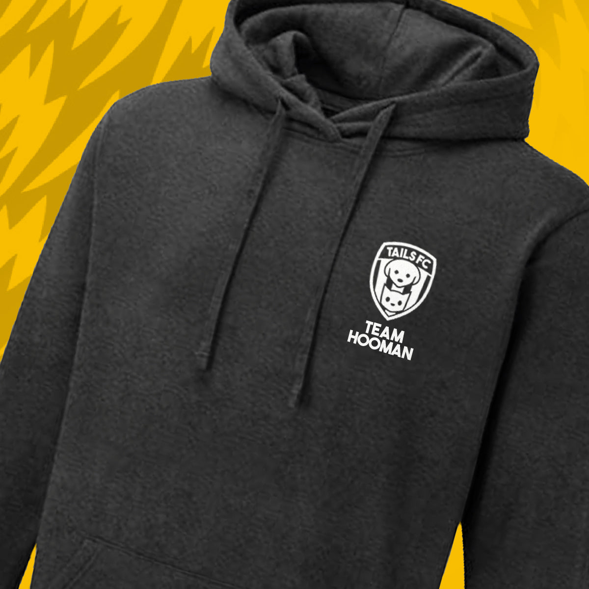 Tails FC Black hoodie with 'Team Hooman' logo on patterned yellow background
