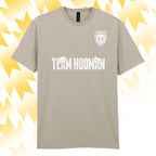 Tails FC Beige t-shirt with 'Team Hooman' text and logo on a yellow abstract background
