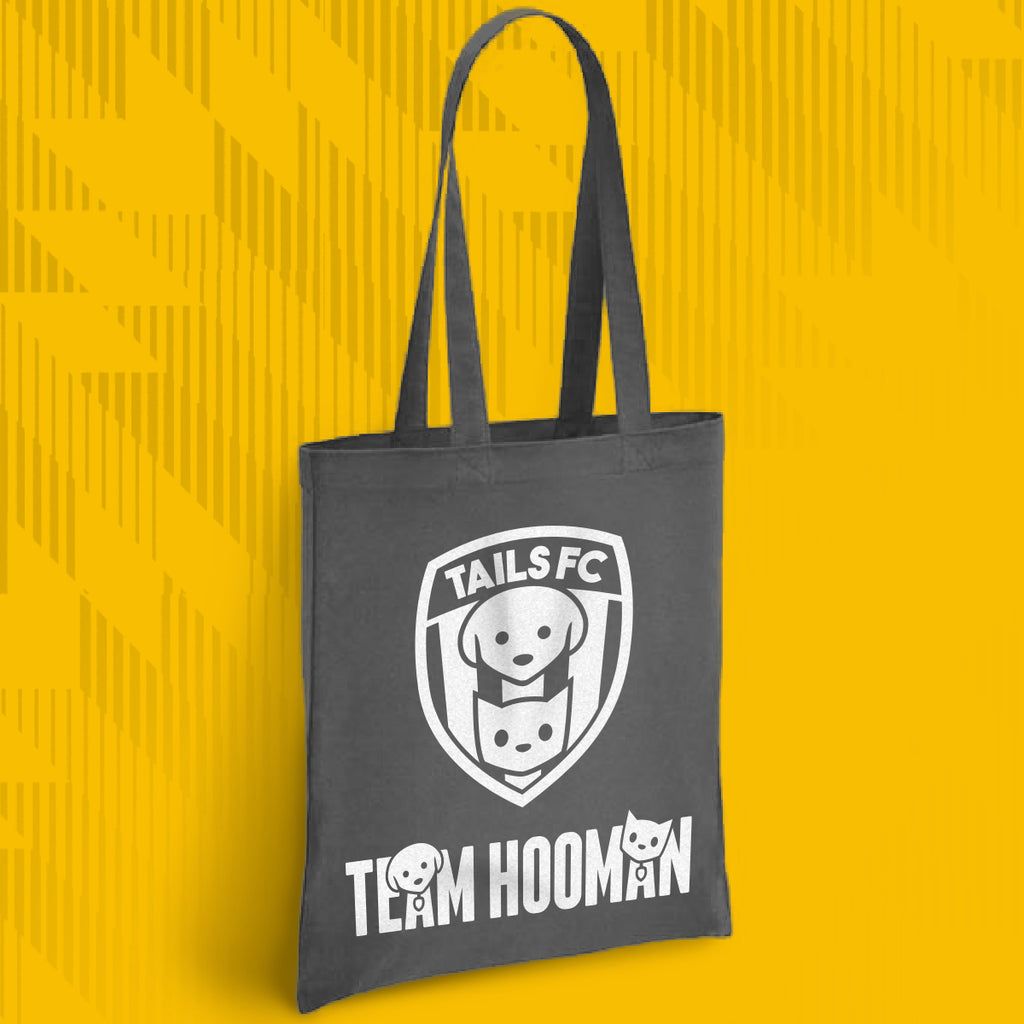 Gray tote bag with 'TAILS FC' and 'Team Hooman' design on a yellow background