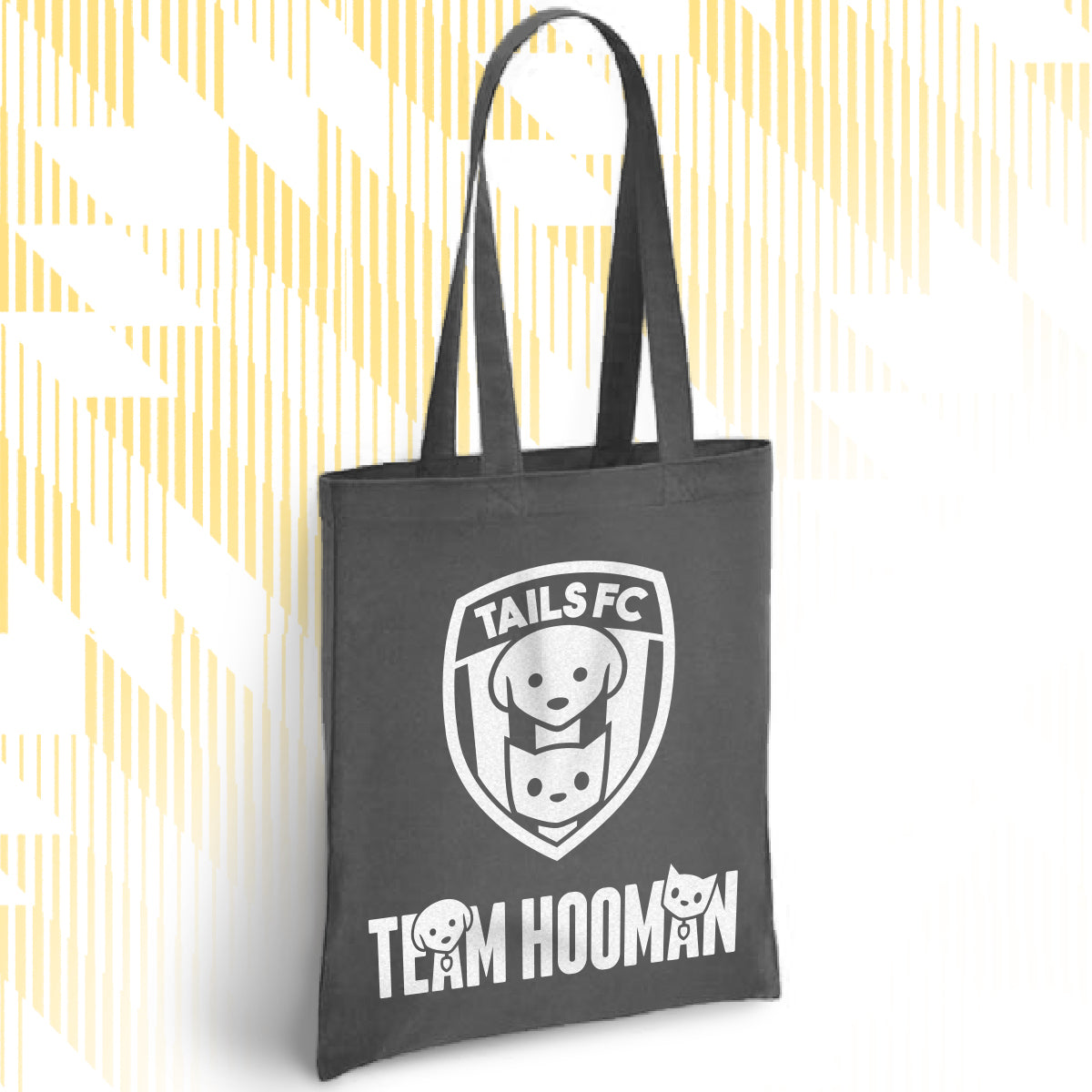 Charcoal tote bag with 'TAILS FC' and 'Team Hooman' design on a white background
