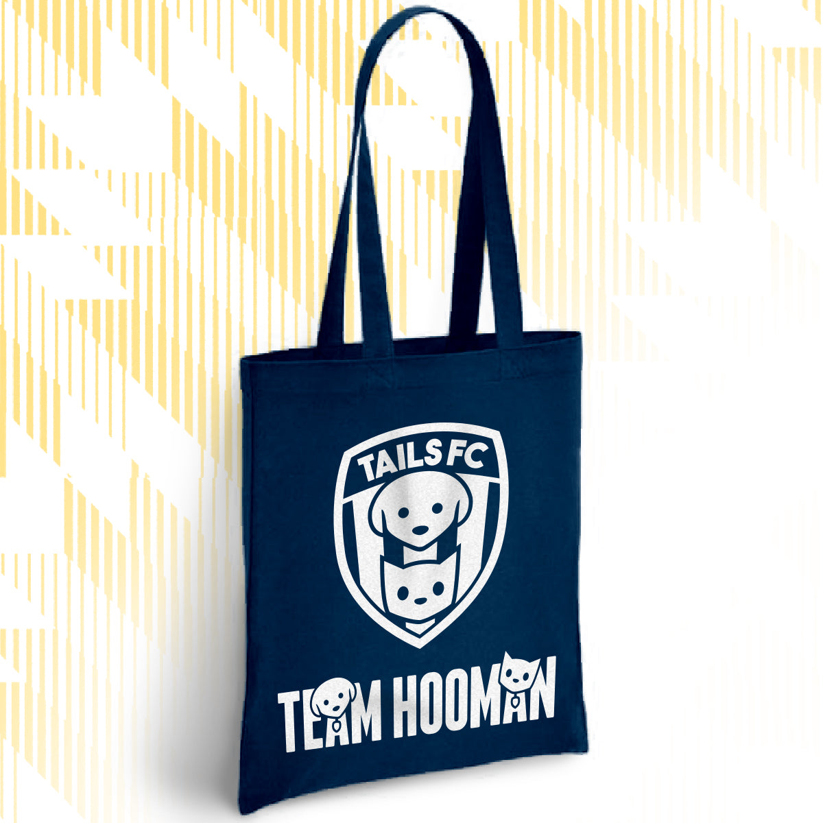 Navy blue tote bag with 'TAILS FC' and 'Team Hooman' logos on a white background