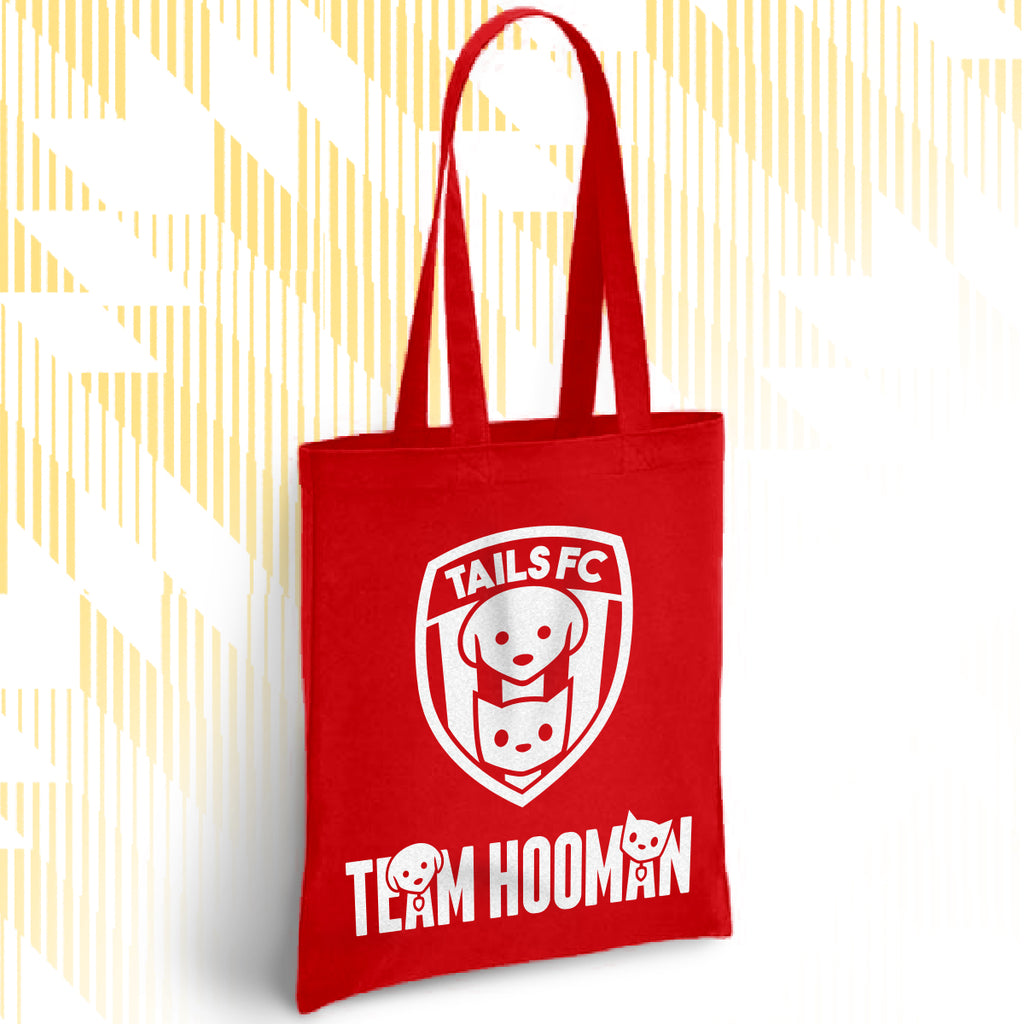 Red tote bag with 'TAILS FC' and 'TEAM HOOMAN' design on a white background