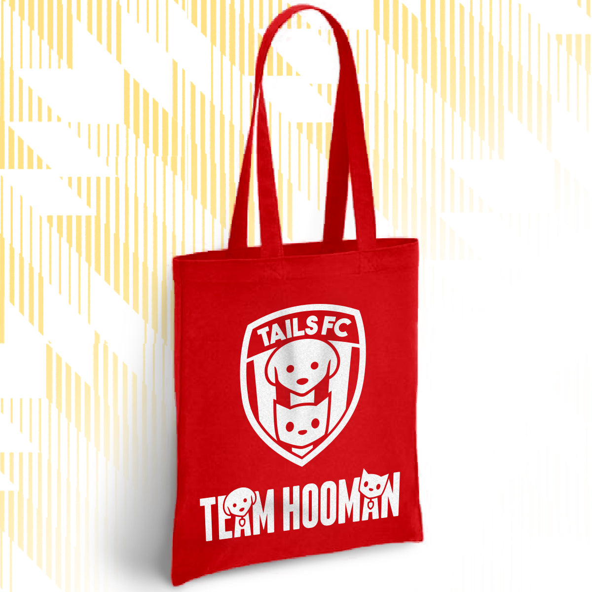 Red tote bag with 'TAILS FC' and 'TEAM HOOMAN' design on a white background