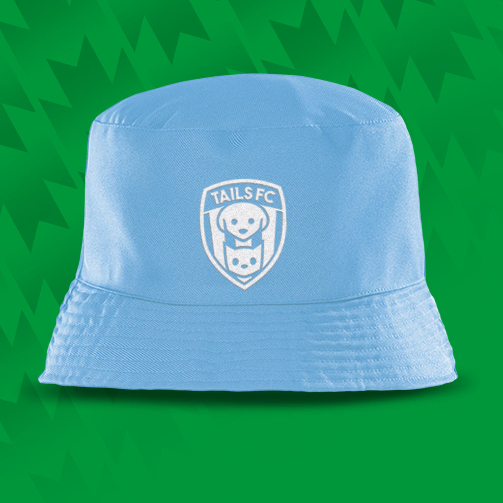 Light blue bucket hat with TAILS FC logo on a green background