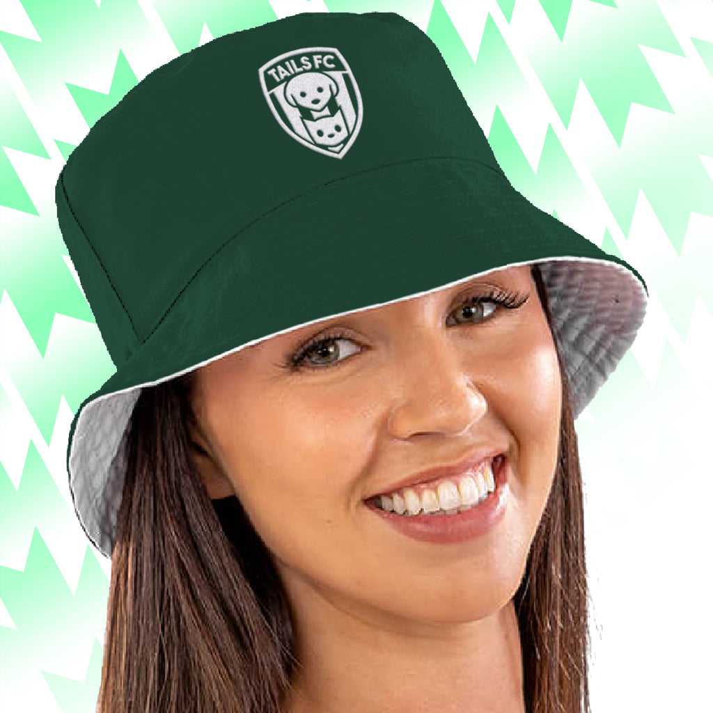 Green Tails FC bucket hat with a logo on a person against a light green background