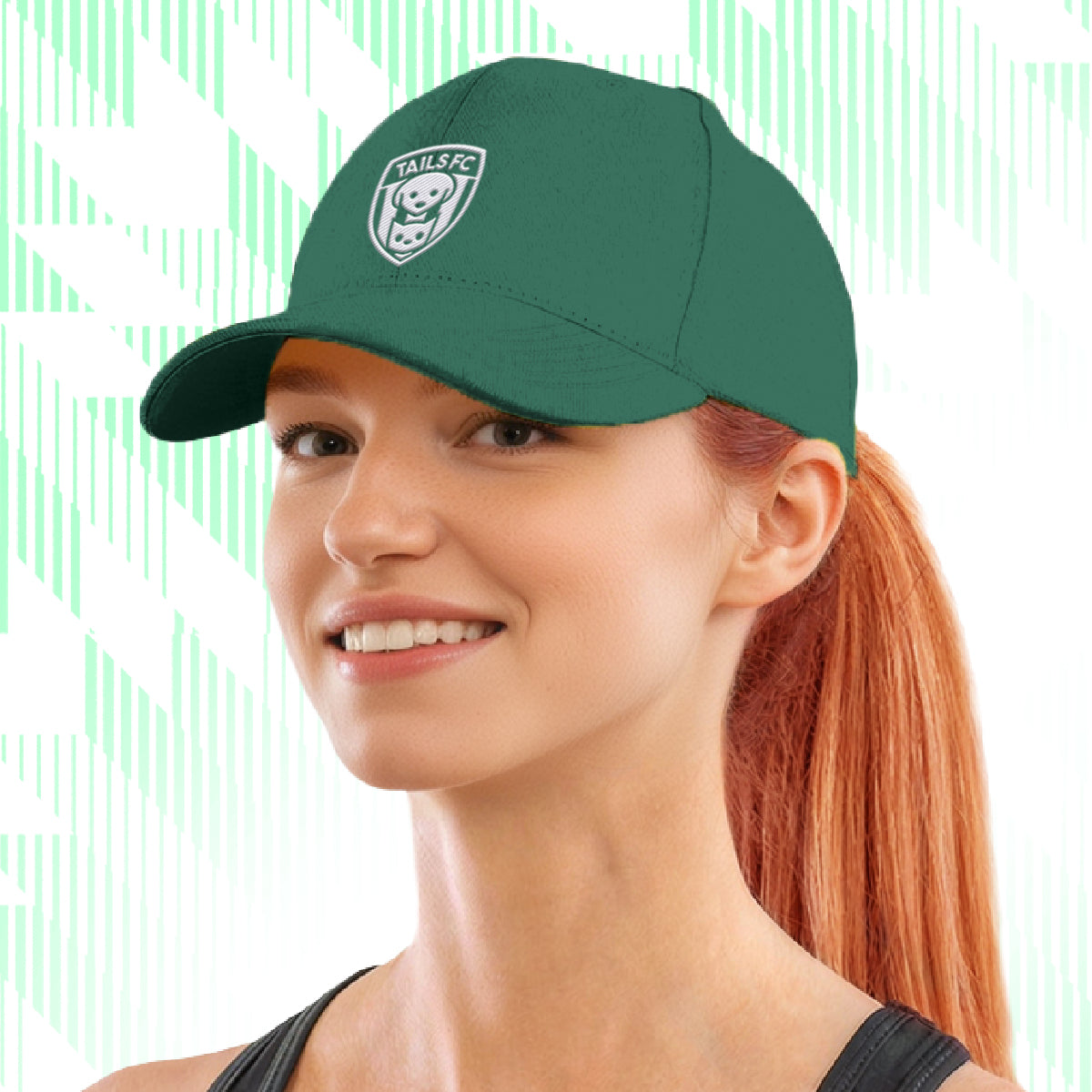 Woman wearing a green cap with Tails FC  logo on a white background