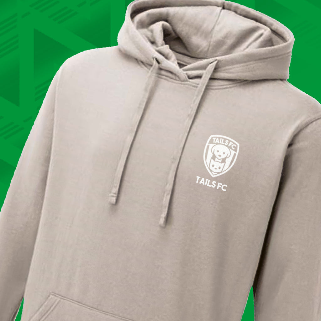Tails FC Beige hoodie with a logo on the chest against a green background