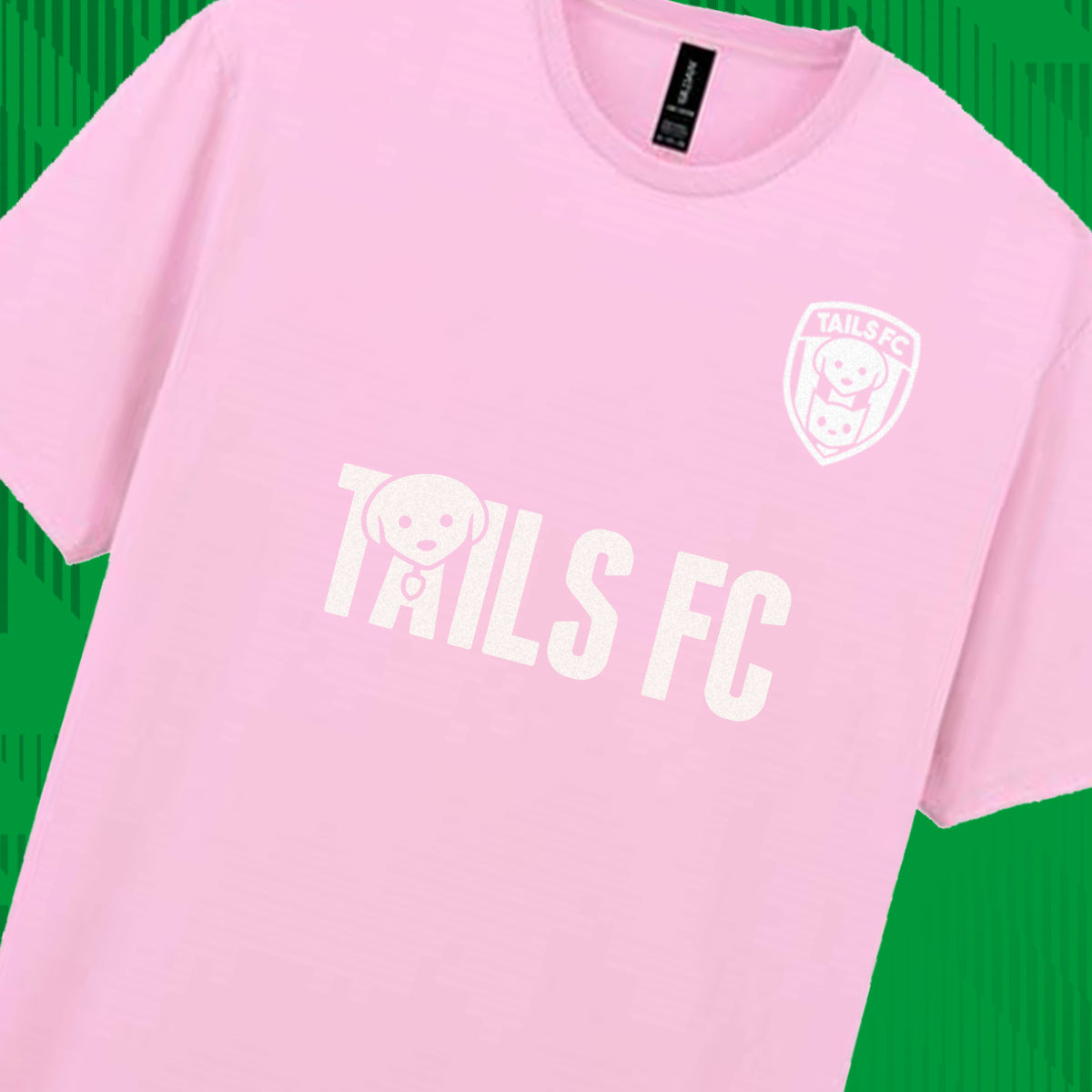 Pink t-shirt with 'TAILS FC' text and logo on a green background