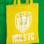 Yellow tote bag with 'TAILS FC' logo on a green background