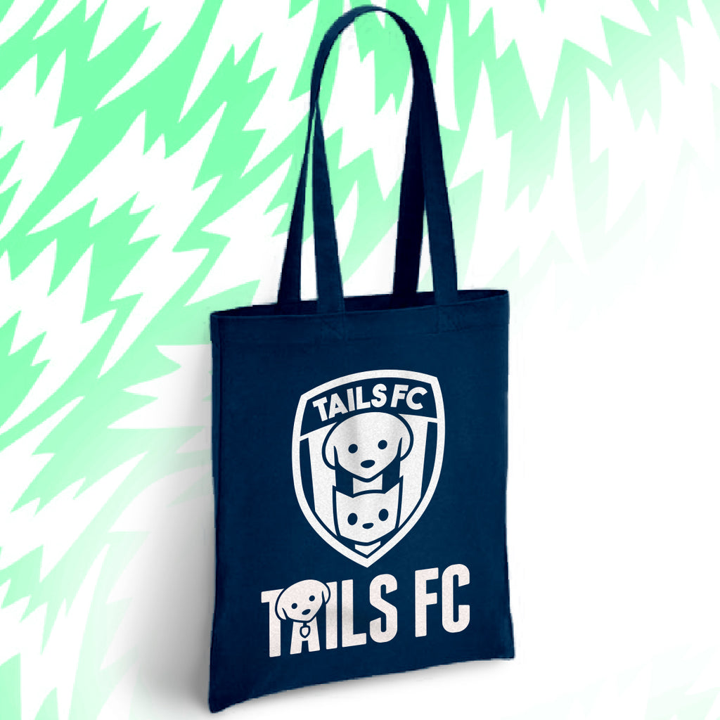 Navy tote bag with 'TAILS FC' logo on a light green background