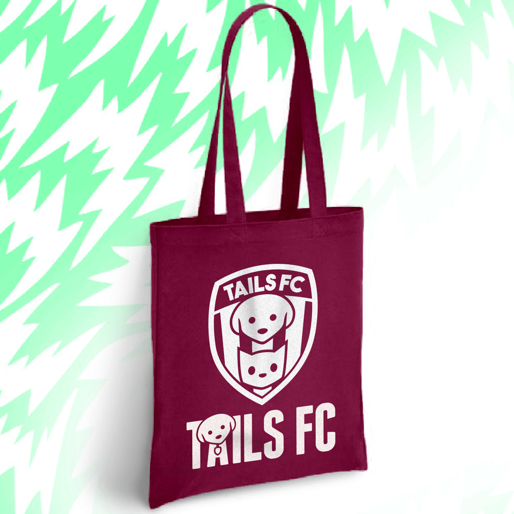 Maroon tote bag with 'TAILS FC' logo on a light green background.